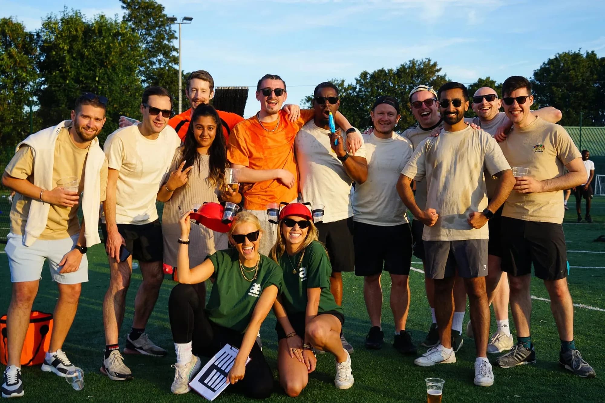 A team celebrating on a sports field at a corporate day