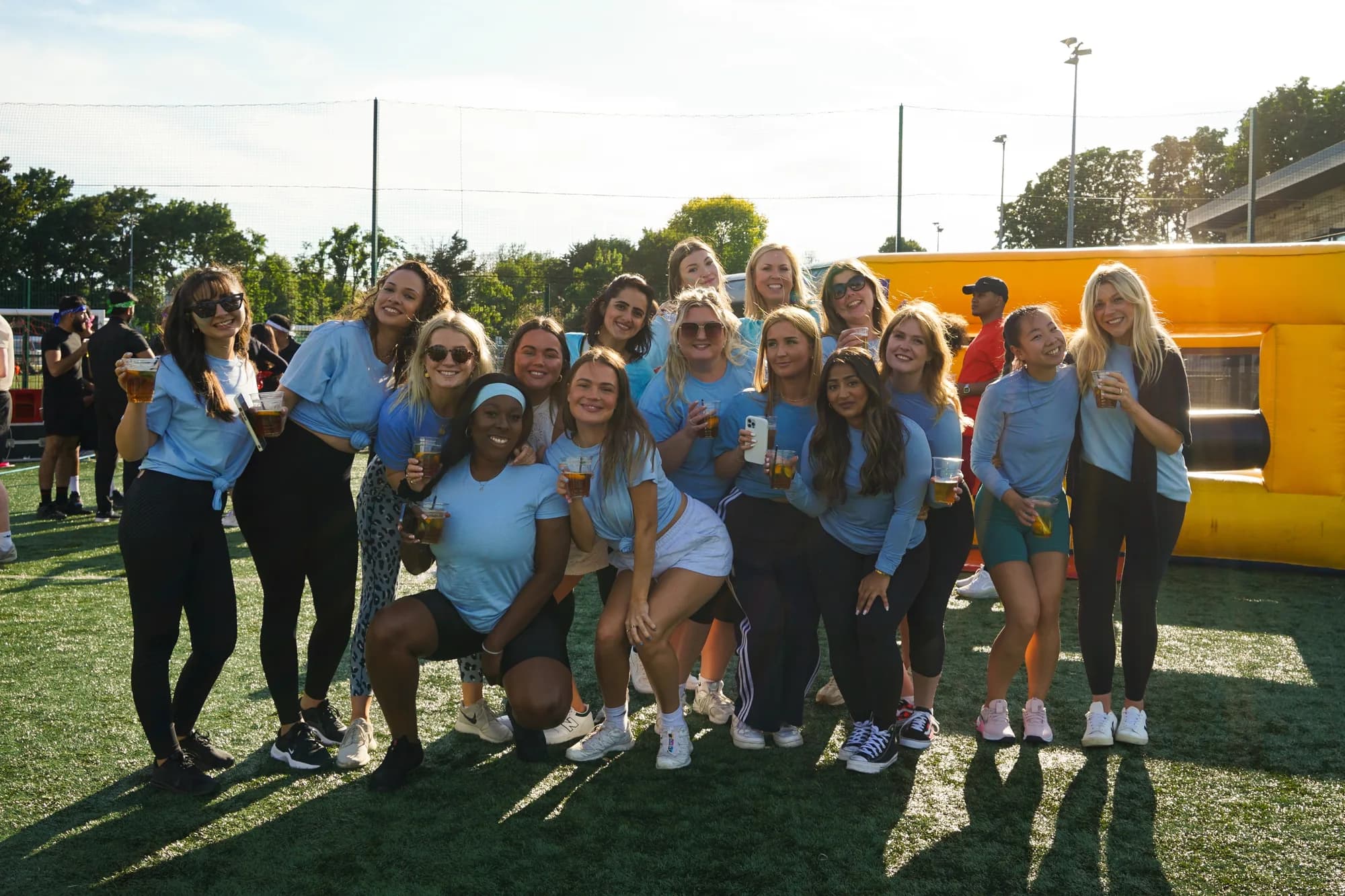 A corporate team lined up on the grass at an Archie's sports day