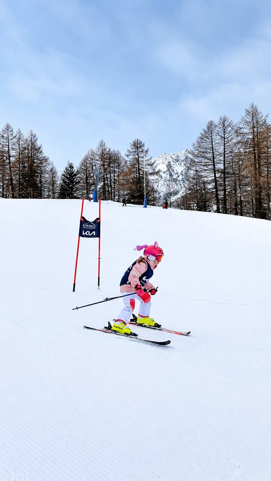 A young skier racing through slalom gates